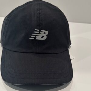 NWT New Balance Women’s Athletic Black Cap with Velcro adjustable back.